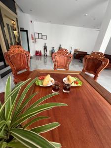 a table with two plates of food on it at Honeybee Villa in Văn Lâm