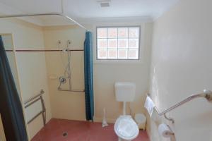 
a bathroom with a toilet, sink, and shower stall at O'Dowds Hotel/Motel Rockhampton in Rockhampton
