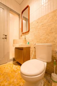 a bathroom with a white toilet and a sink at Villa Ceria Dukuh in Timuran +48 photos