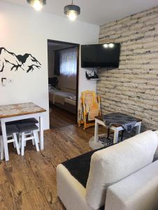 a living room with a couch and a table at Czesławka in Zawoja