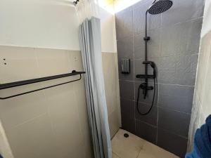 a bathroom with a shower with a shower curtain at Sea Sky Dreams in Kuta Lombok