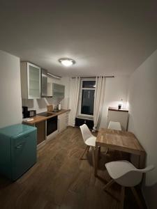a kitchen with a table and chairs in a room at Lee 42,8 in Bremerhaven