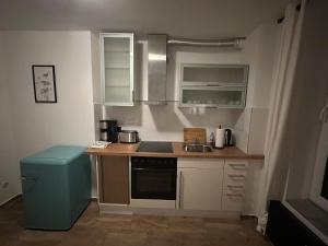 a small kitchen with a sink and a stove at Lee 42,8 in Bremerhaven