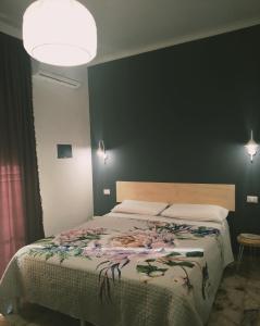 a bedroom with a large bed and a black wall at Nonno Turiddu Elegant Rooms in Caccamo