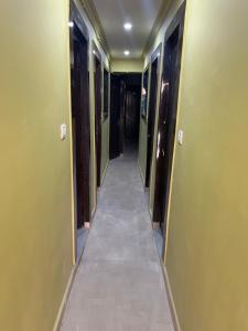 a hallway with green walls and a tile floor at Hotel Anusuiya palace in Lucknow