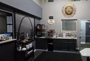 a room with a counter with a counter top with aitating at Super 8 by Wyndham Belleville St. Louis Area in Belleville