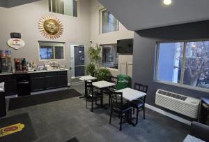 a restaurant with tables and chairs in a room at Super 8 by Wyndham Belleville St. Louis Area in Belleville