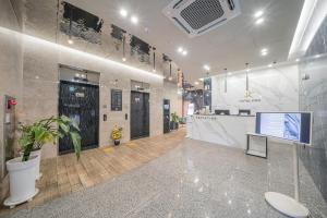 a lobby of a building with a reception desk at Hotel PIED Suseong in Daegu
