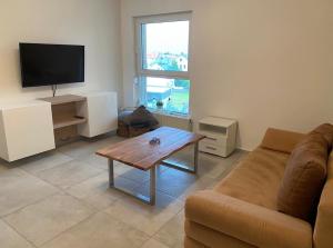 a living room with a couch and a coffee table at Deck 3 in Cuxhaven