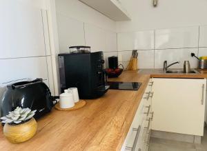 a kitchen with a counter top with a coffee maker at Deck 3 in Cuxhaven