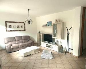 a living room with a couch and a television at Cà del Fili in Lenno