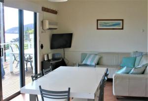 a living room with a white table and a couch at Penneshaw Beach House in Penneshaw