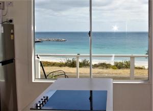 a kitchen with a view of the ocean from a window at Penneshaw Beach House in Penneshaw