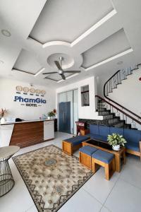 a living room with a ceiling fan and stairs at Pham Gia Hotel Mui Ne in Mui Ne