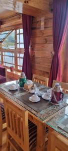 a dining room table with a table and chairs at Hotel Sheryang in Namche +23 photos