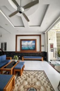 a living room with a ceiling fan at Pham Gia Hotel Mui Ne in Mui Ne
