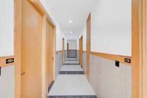 a hallway with wooden doors and a long aisle at Townhouse Roorkee Bypass in Roorkee