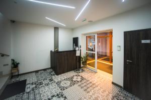 an empty room with a door and a tile floor at Hotel U Kostela in Modřice