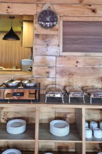 a kitchen with a clock on a wooden wall at Hotel Sheryang in Namche