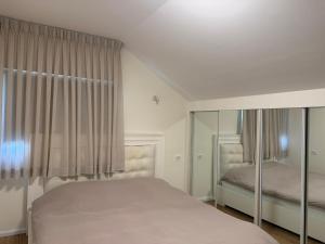 a white bedroom with a bed and a window at Las Palmas in Eilat +16 photos