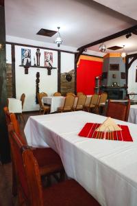 a dining room with a white table and chairs at Комплекс Тракийски стан in Asenovgrad +109 photos