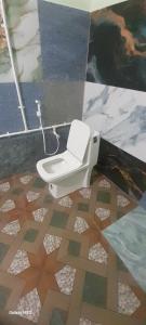 a bathroom with a toilet in a tile floor at Mahadev Residency templeview in Tiruvannāmalai +13 photos
