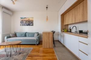a living room with a couch and a table at HM Apartments in Inđija