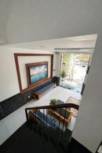 a view of a living room with a couch and a television at Pham Gia Hotel Mui Ne in Mui Ne