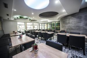 a dining room with wooden tables and chairs at Hotel U Kostela in Modřice