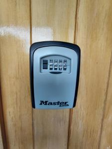 a soap dispenser is attached to a wooden wall at Stirling St Surf Villa in Dunedin