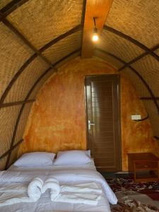 a bedroom with a bed in a round room at Giri Garden Sunset Glamping in Gitgit