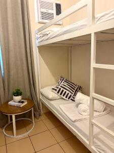 a bunk bed in a room with a table at 8 Spatial Condo in Davao City +14 photos