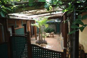 an outdoor patio with benches and plants on a building at Sala Prabang Hotel in Luang Prabang