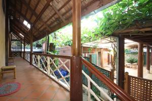 a balcony of a house with a wooden railing at Sala Prabang Hotel in Luang Prabang