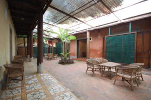 an outdoor patio with a table and chairs at Sala Prabang Hotel in Luang Prabang