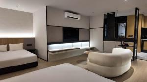 a hotel room with a bed and a chair at Urban Inn, Alor Setar in Alor Setar +98 photos