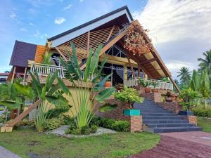 a house withtropical plants in front of it at Gamboa's Orchard Malilipot Albay in Malilipot