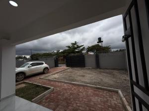 a garage with a car parked in a driveway at Samash villas 2 in Lusaka