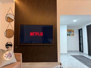 a television on a wall with the netflix sign on it at Samash villas 2 in Lusaka