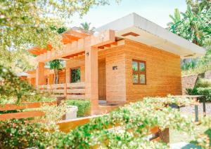 a small wooden house in the middle of a garden at Gamboa's Orchard Malilipot Albay in Malilipot