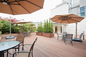 an outdoor patio with tables and chairs and umbrellas at Days Hotel by Wyndham Seoul Myeongdong in Seoul