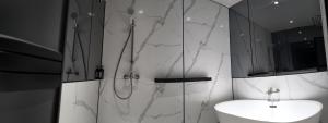 a white bathroom with a shower and a sink at Urban Inn, Alor Setar in Alor Setar