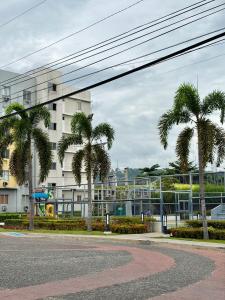 a street with palm trees in front of a building at 8 Spatial Condo in Davao City