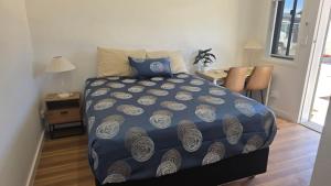 a bedroom with a bed and a table and chairs at Heritage City Motor Inn in Broken Hill +3 photos