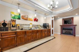 a food counter in a restaurant with a fireplace at Quality Inn Alexander City in Alexander City