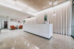 an office lobby with a reception desk and chairs at Clarion Hotel Townsville in Townsville