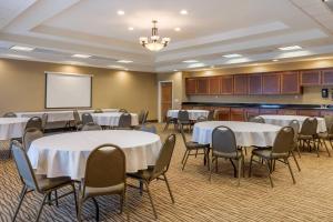 a conference room with tables and chairs and a whiteboard at Comfort Suites Barstow near I-15 in Barstow +35 photos