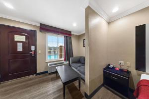 a room with a desk and a chair and a door at Econo Lodge Inn & Suites Escondido Downtown in Escondido
