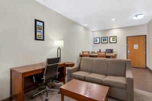 a living room with a couch and a desk at Comfort Suites Brenham in Brenham +24 photos
