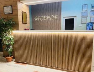 a reception desk in a lobby with a sign at Hotel Moldova in Bîrlad